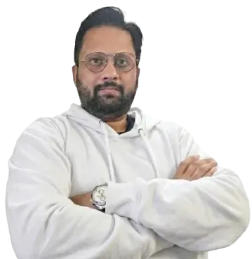 Headshot: Adi Rao — direct, slightly serious expression. Not a studio smile. Face clearly visible. Natural or office light. Could be seated at desk, jacket or casual smart.